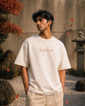 Person wearing a white t-shirt with Japanese text in an outdoor setting